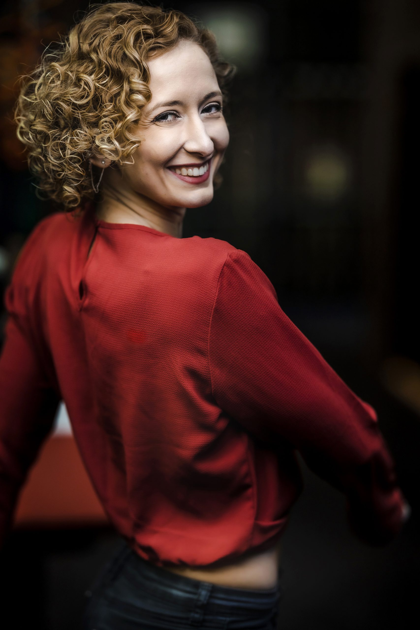 Louisa Poletti smiling in a red shirt